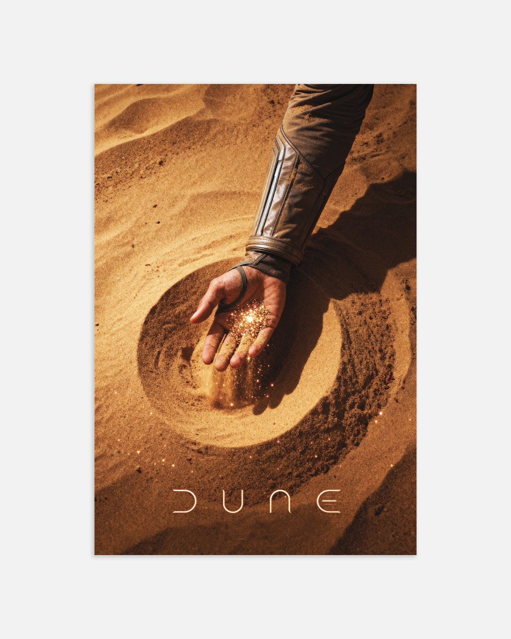 Poster of a hand touching sand with 'Dune' branding